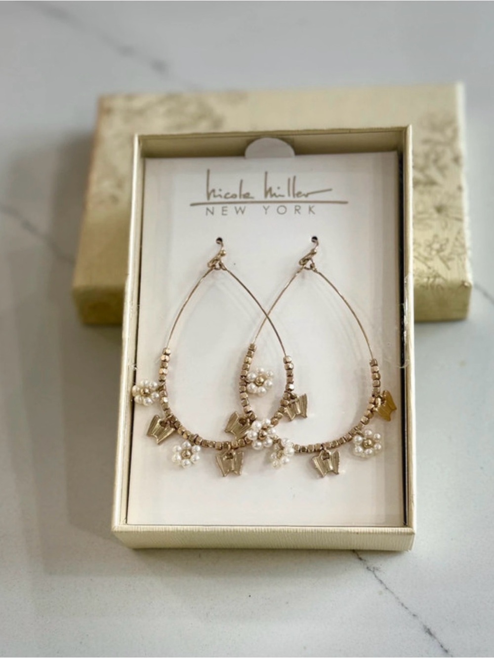 Gold tone Butterfly  and flower charm large Hoop Earrings by Nicole Miller